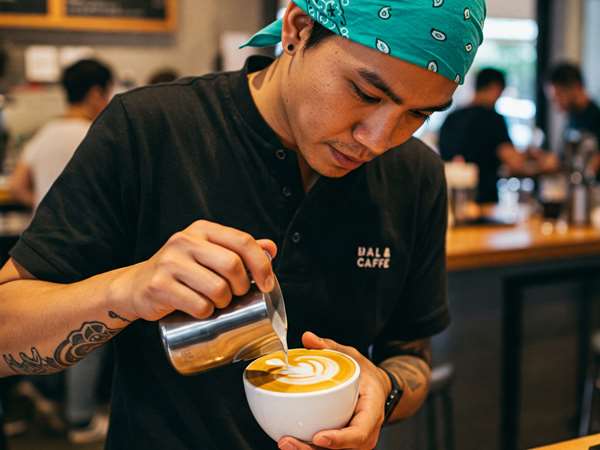 barista making latte
